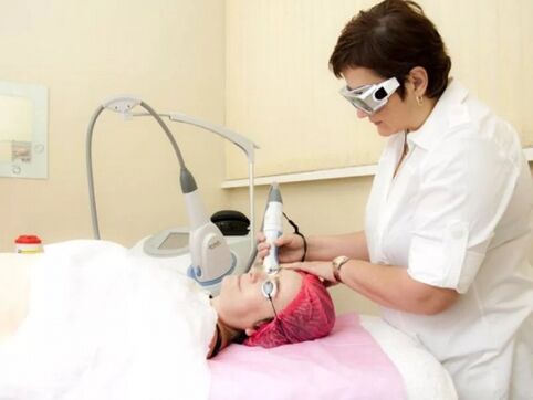 Beautician performs laser rejuvenation procedures